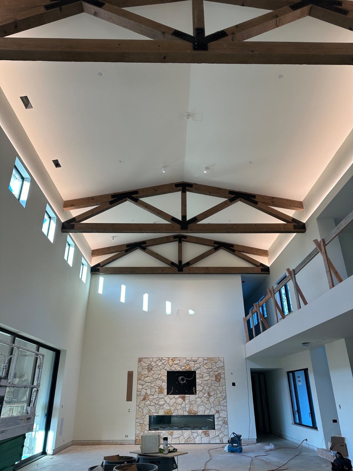 Custom and recessed lighting project in Paso Robles: recessed cans and cove lighting in a vaulted great room with exposed wood trusses